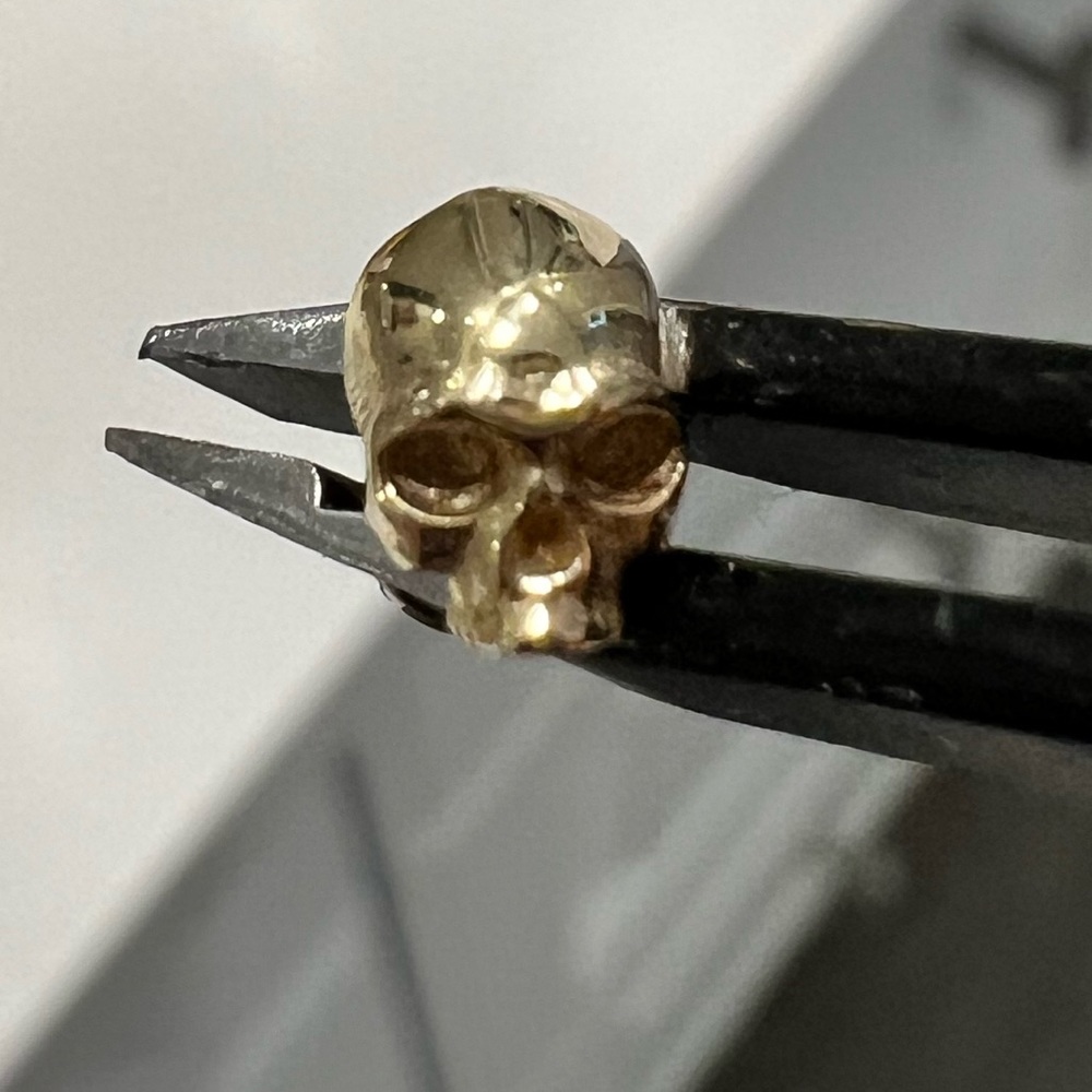 Gold skull earring